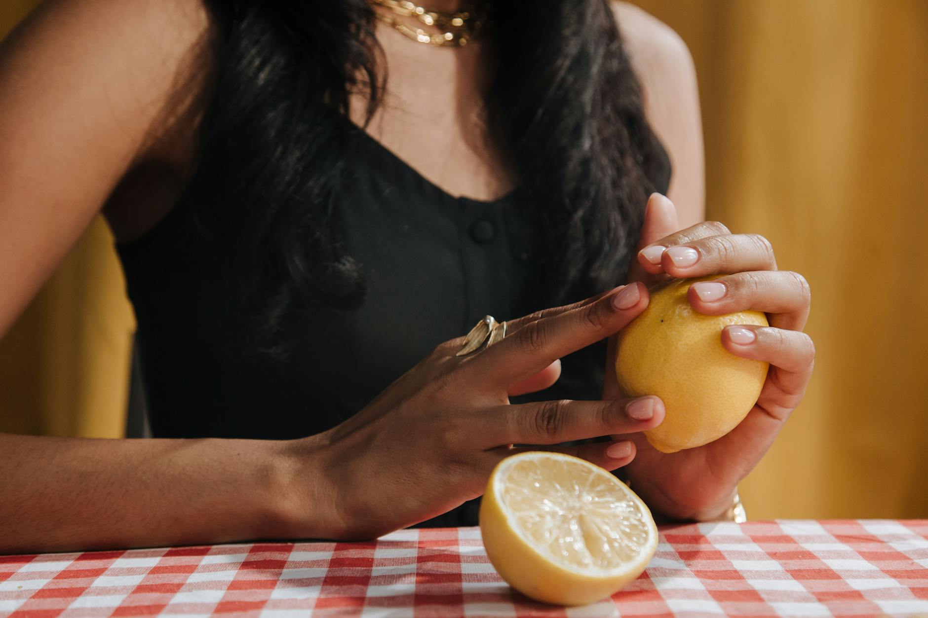 Yellow silicone lemon vibrator surrounded by fresh bananas on bright yellow background